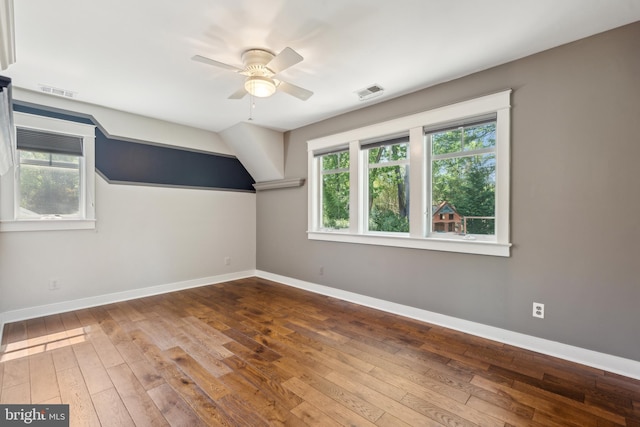 additional living space with plenty of natural light, hardwood / wood-style floors, and visible vents