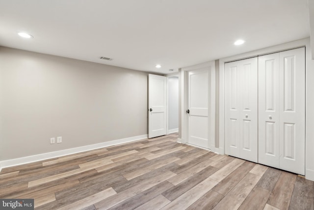below grade area featuring visible vents, recessed lighting, light wood finished floors, and baseboards