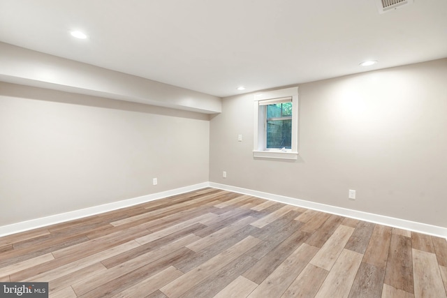 below grade area with recessed lighting, baseboards, visible vents, and light wood-style flooring