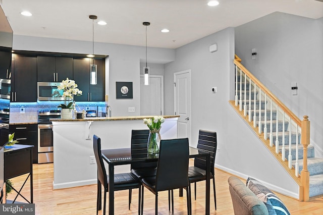 14184 Haro Trl, Gainesville, VA 20155 - dining area with light wood-type flooring, stairway, and recessed lighting