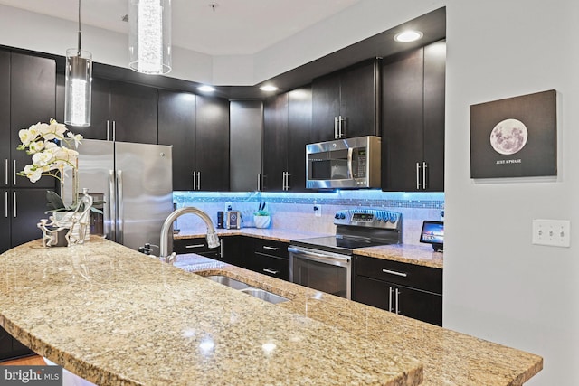 14184 Haro Trl, Gainesville, VA 20155 - kitchen with a sink, a center island with sink, dark cabinets, and appliances with stainless steel finishes