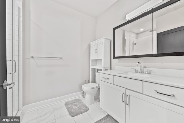 bathroom featuring a shower stall, vanity, baseboards, toilet, and marble finish floor