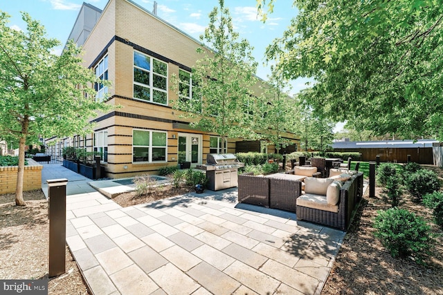 view of patio / terrace featuring an outdoor kitchen, an outdoor living space, french doors, and a grill