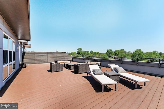 wooden terrace with an outdoor hangout area