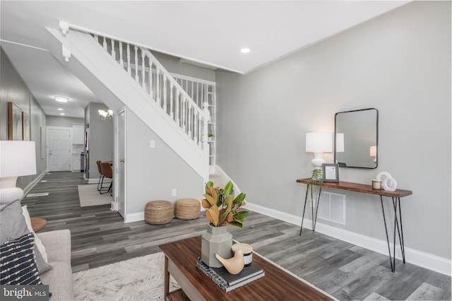living area with stairway, wood finished floors, baseboards, visible vents, and recessed lighting