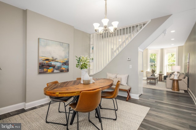 dining room featuring stairway, baseboards, dark wood-style flooring, and an inviting chandelier