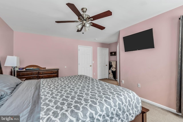 bedroom featuring baseboards, ceiling fan, and light carpet