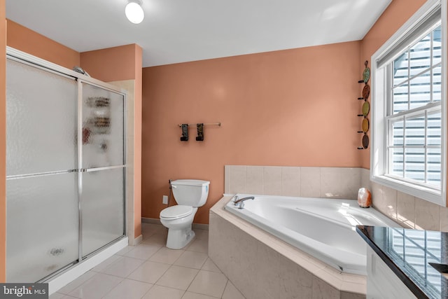 full bath featuring tile patterned flooring, a shower stall, toilet, and a wealth of natural light