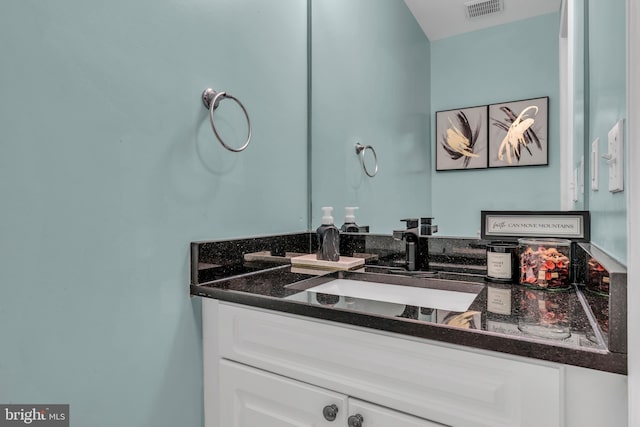 bathroom featuring vanity and visible vents