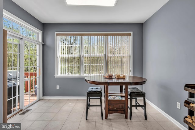 dining space featuring light tile patterned flooring, baseboards, and visible vents