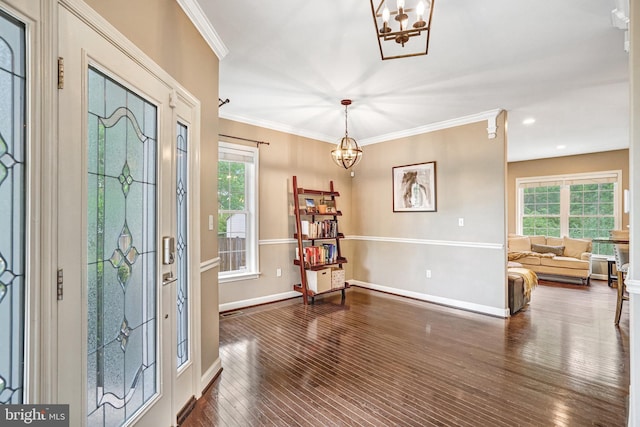 entrance foyer featuring a chandelier, dark wood-style floors, crown molding, baseboards, and recessed lighting