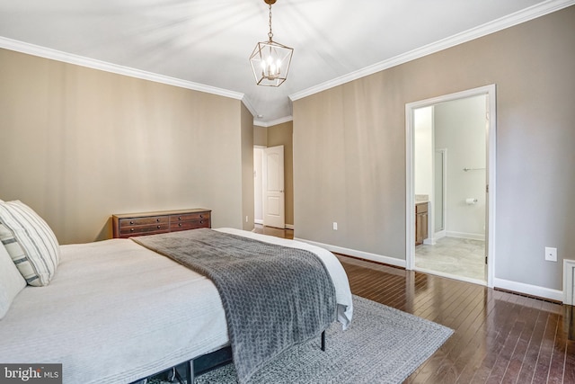bedroom featuring dark wood-type flooring, ornamental molding, a chandelier, baseboards, and ensuite bathroom