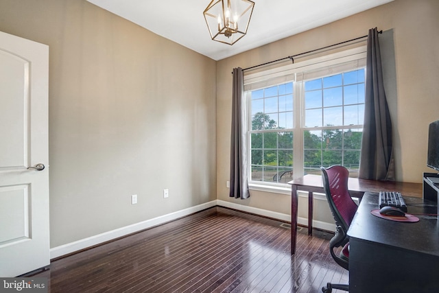 home office with baseboards, wood-type flooring, and a chandelier