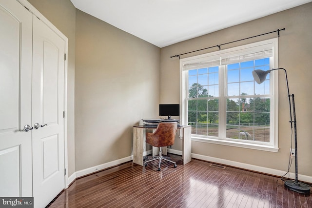 home office with baseboards and hardwood / wood-style flooring