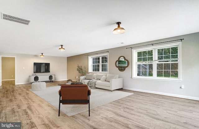 living area with wood finished floors and baseboards