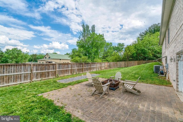 view of patio featuring an outdoor fire pit and central AC