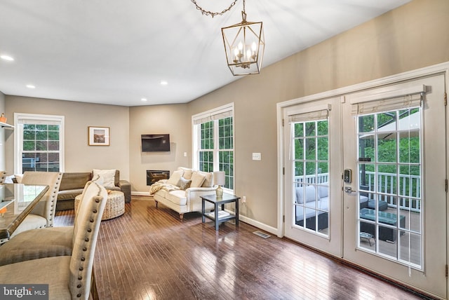 living room with a chandelier, healthy amount of natural light, hardwood / wood-style floors, baseboards, and recessed lighting