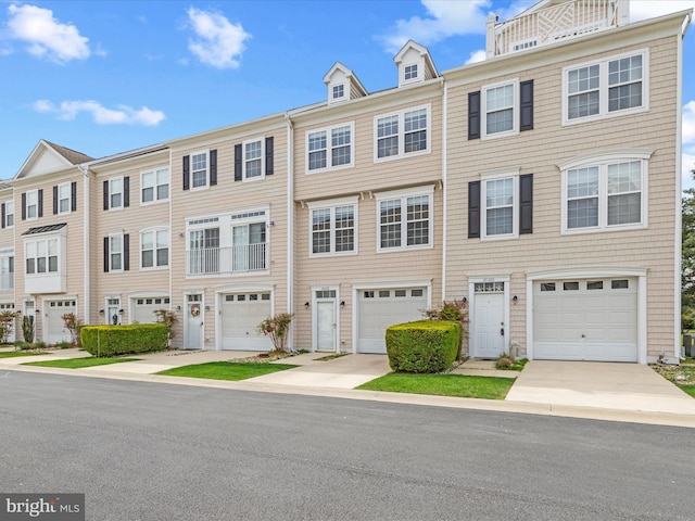 view of property with driveway and an attached garage