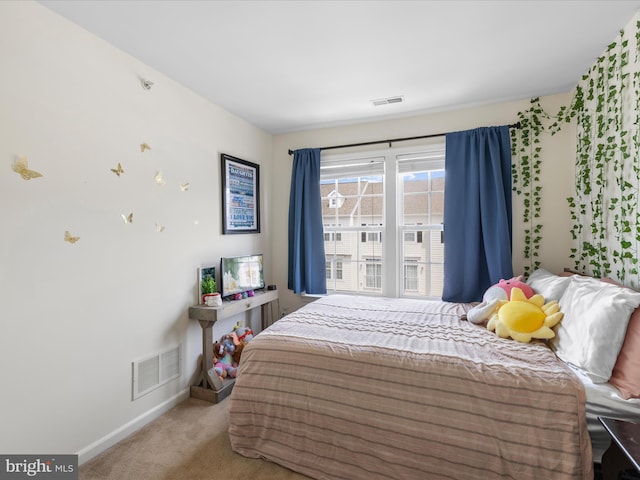 bedroom featuring baseboards, visible vents, and carpet