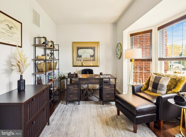 office area with visible vents and wood finished floors