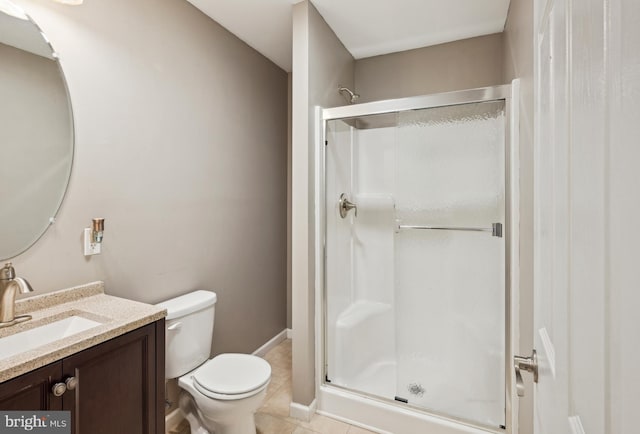 full bathroom featuring vanity, tile patterned flooring, toilet, baseboards, and a shower stall