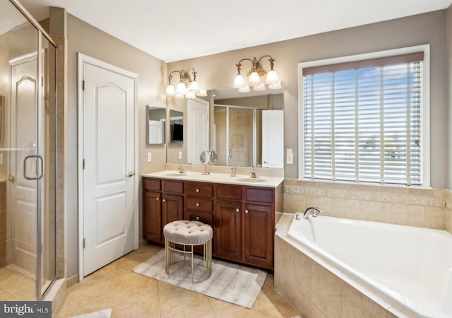 bathroom with a sink, tile patterned flooring, double vanity, a shower stall, and a garden tub