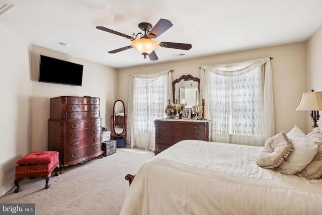 bedroom featuring visible vents, a ceiling fan, and carpet