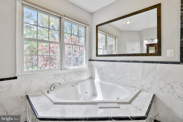 bathroom with a wealth of natural light and a jetted tub