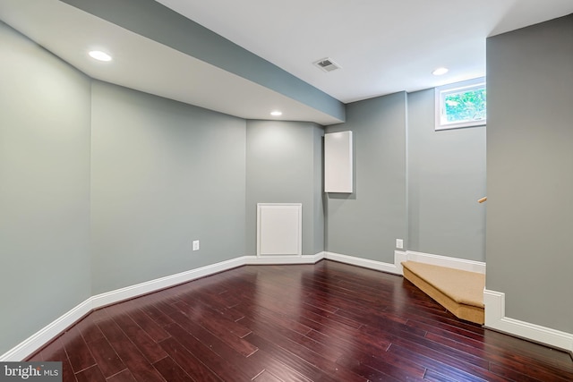 basement featuring baseboards, wood finished floors, visible vents, and recessed lighting