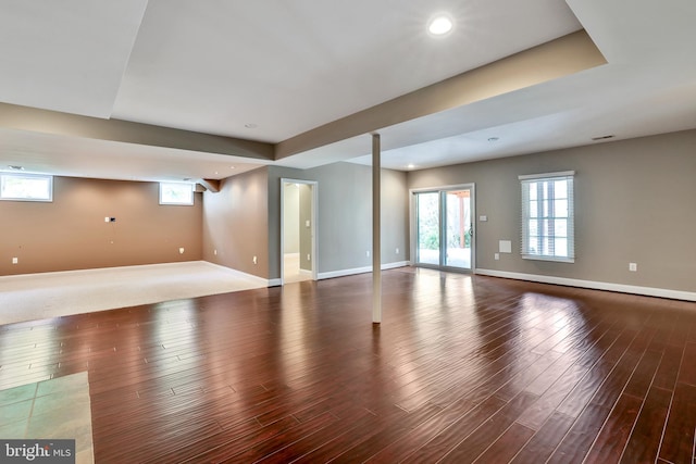 unfurnished living room featuring recessed lighting, wood finished floors, and baseboards