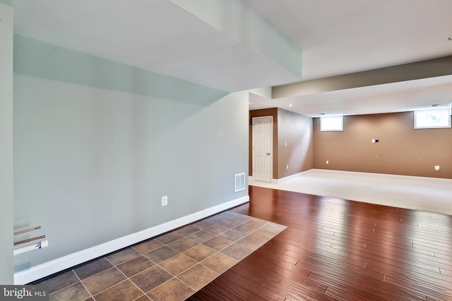 basement featuring baseboards and visible vents