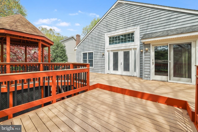 wooden terrace with french doors and a gazebo