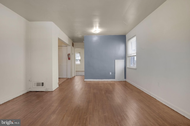 spare room with wood finished floors and baseboards
