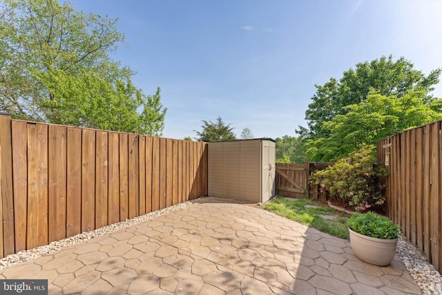 view of patio featuring a fenced backyard and a gate
