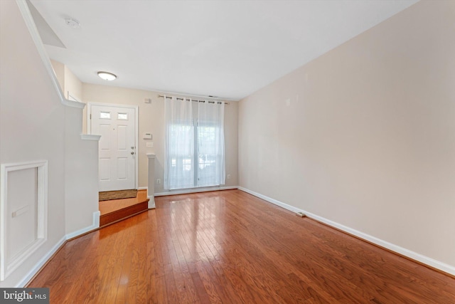 interior space featuring baseboards and wood finished floors