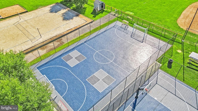 view of basketball court featuring a yard, community basketball court, fence, and a tennis court