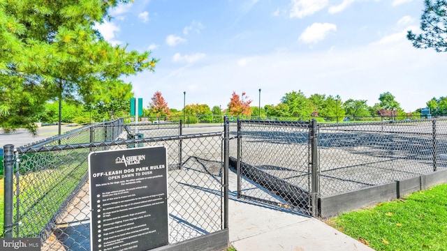 view of home's community with fence and a gate