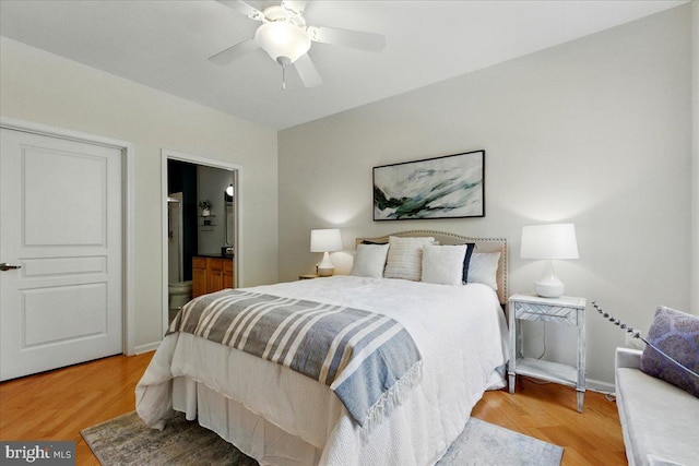 12000 Market St Unit 189, Reston, VA 20190 - bedroom with baseboards, light wood-style floors, ensuite bath, and ceiling fan