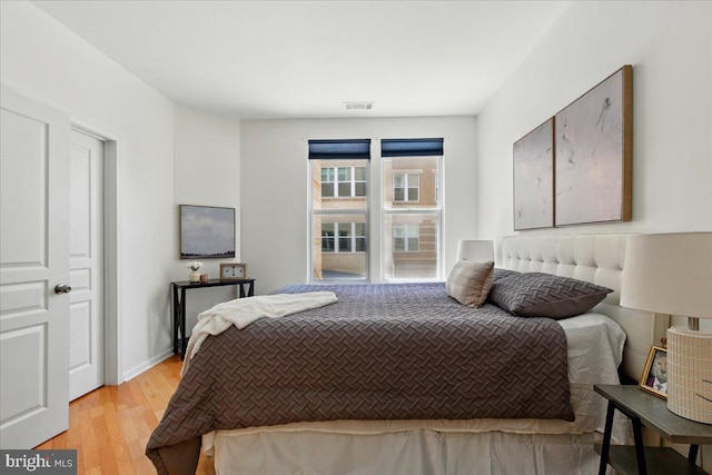 12000 Market St Unit 189, Reston, VA 20190 - bedroom featuring light wood-type flooring and visible vents