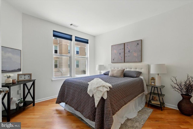 12000 Market St Unit 189, Reston, VA 20190 - bedroom with baseboards, light wood finished floors, and visible vents