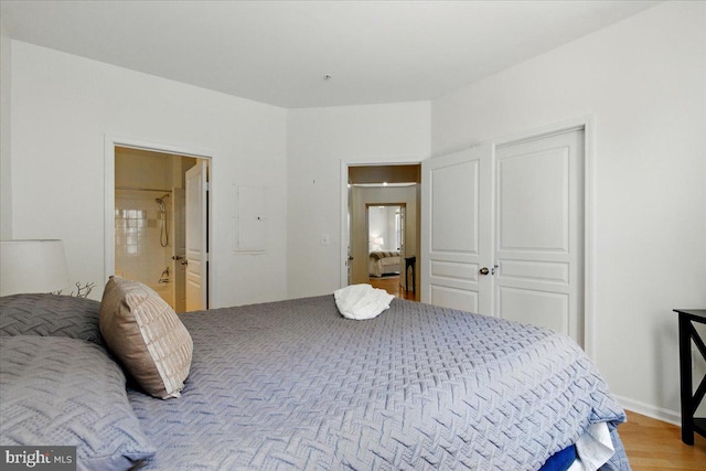 12000 Market St Unit 189, Reston, VA 20190 - bedroom featuring electric panel, ensuite bath, and wood finished floors