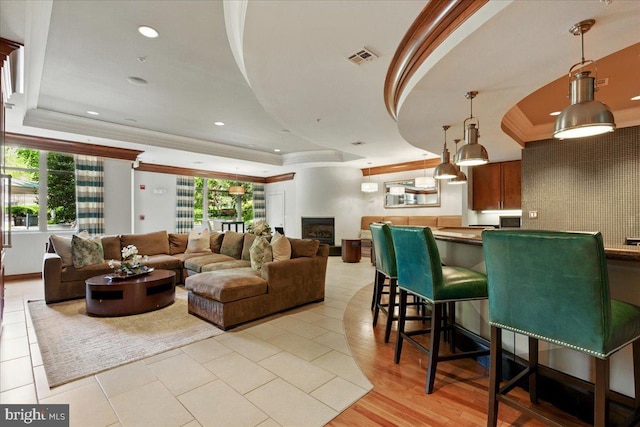 12000 Market St Unit 189, Reston, VA 20190 - living area with ornamental molding, a tray ceiling, visible vents, and plenty of natural light