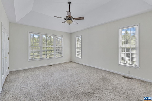 unfurnished room with baseboards, a ceiling fan, visible vents, and carpet flooring