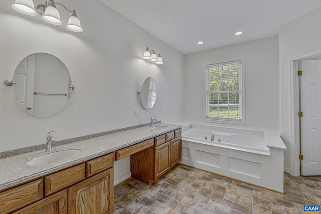 full bathroom featuring a sink, double vanity, and stone finish flooring