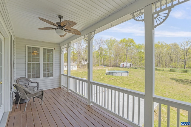 wooden terrace featuring a fenced backyard, a yard, and ceiling fan