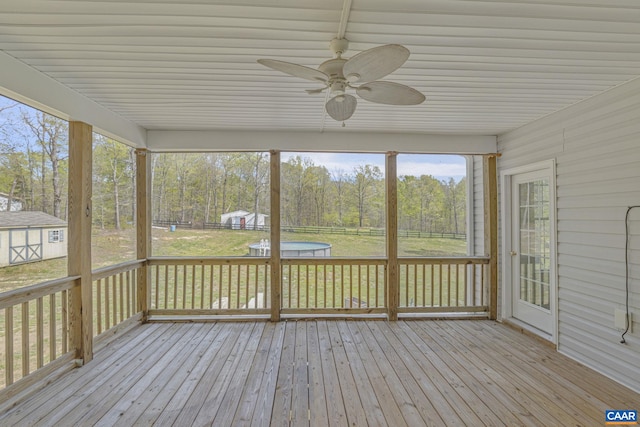 unfurnished sunroom featuring ceiling fan