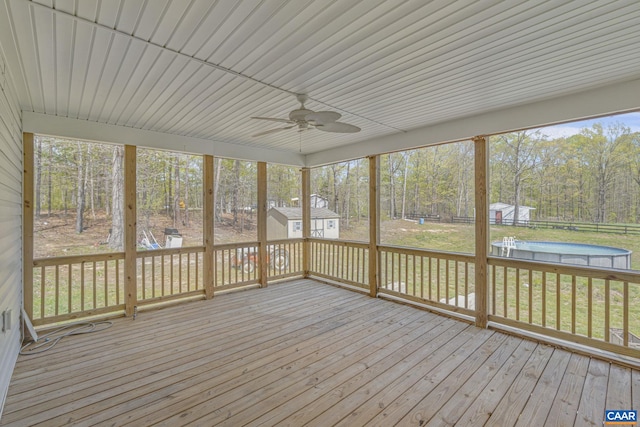 unfurnished sunroom with a ceiling fan