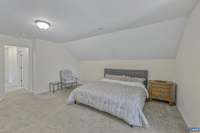 bedroom with baseboards, lofted ceiling, visible vents, and carpet floors