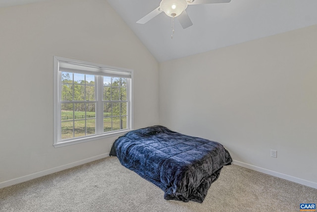carpeted bedroom with ceiling fan, vaulted ceiling, and baseboards