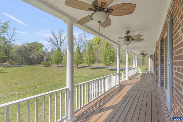 deck featuring a lawn, a porch, and ceiling fan